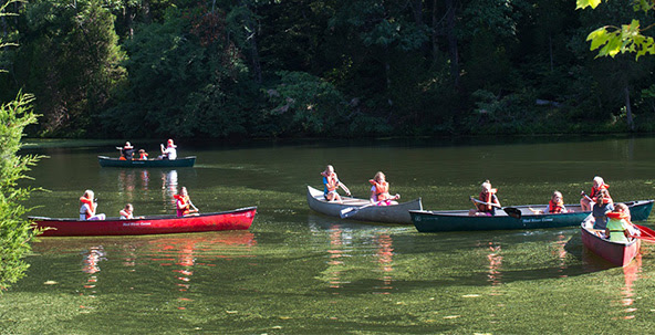 campers canoeing on lake