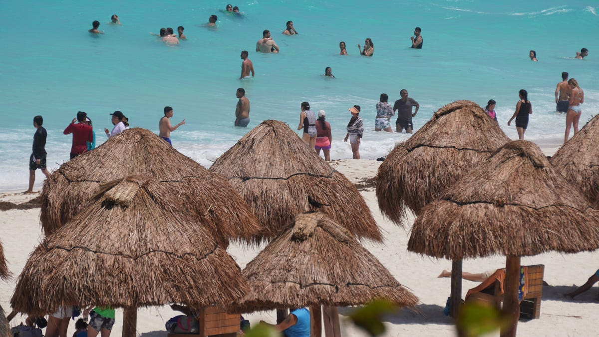 Beachgoers enjoy before the potential arrival of Hurricane Beryl in Cancun, Quintana Roo State, Mexico, on July 3, 2024.