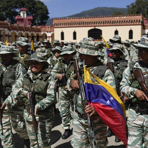 Government-backed militias stand before a march in Caracas, Venezuela, Tuesday, Jan. 7, 2025, days ahead of President Nicolás Maduro's inauguration for a third term. (AP Photo/Matias Delacroix)