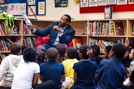 Rep. T. Carter reads to  a classroom of children. March is Reading Month.
