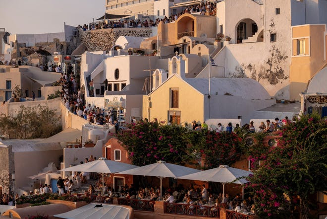 Los turistas esperan para ver la famosa puesta de sol de Santorini, en Santorini, Grecia, el 25 de julio de 2024.