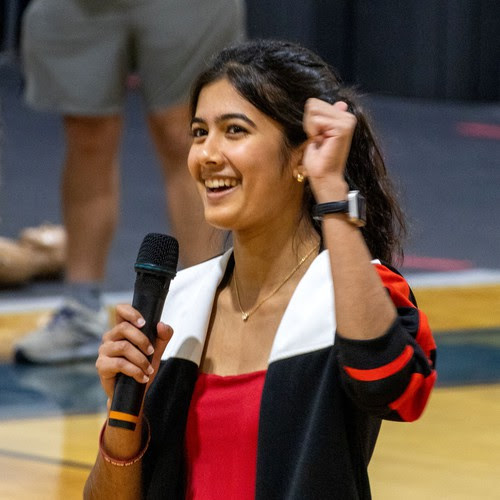 a candid photo of Rhea Sinha as she addresses the crowd at her CPR event