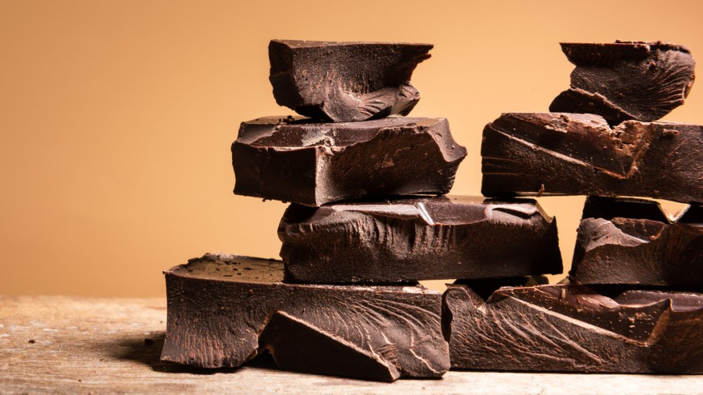 Squares of dark chocolate stacked on a table