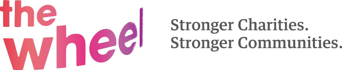 The Wheel logo in peach-purple font against a white background. To the right of this is their slogan in dark-grey lettering, which reads: 'Stronger Charities. Stronger Communities.'
