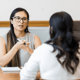 Employee speaking with her manager during a mid-year review.