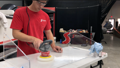 Man Buffing Plexiglass Windshield