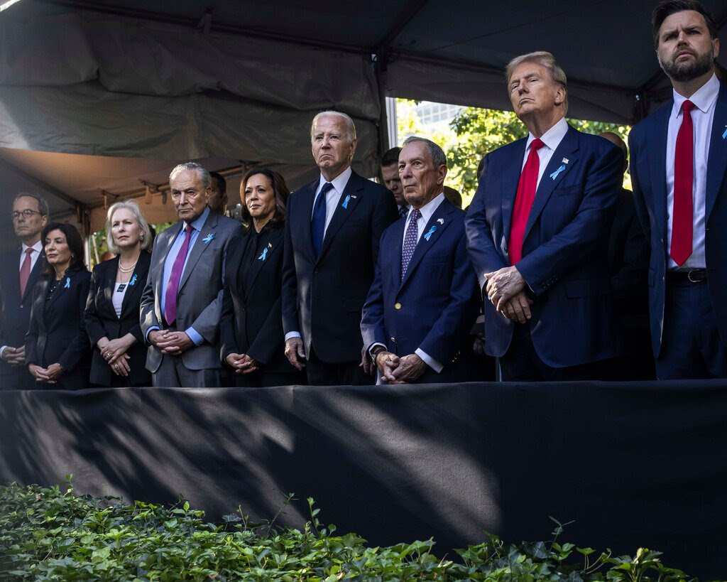 (From right): JD Vance, Donald Trump, Michael Bloomberg, President Biden, Vice President Harris, Chuck Schumer,Kirsten Gillibrandd and Gov. Kathy Hochul stand and watch proceedings at a memorial service.