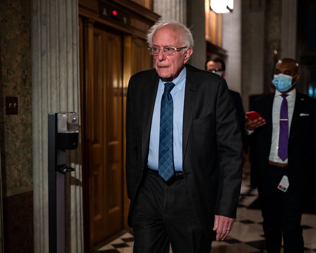 Senator Bernie Sanders walking a hallway of the Capitol.