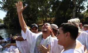 Christian pilgrims from Brazil during a mass baptism ceremony in the waters of the Jordan river – many evangelical groups operate in Israel.
