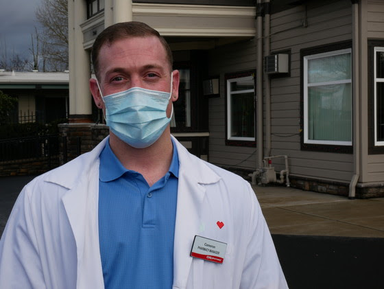 CVS Pharmacy Manager, Cameron Schmitt, stands in front of Village Manor where a COVID-19 vaccination clinic was held today