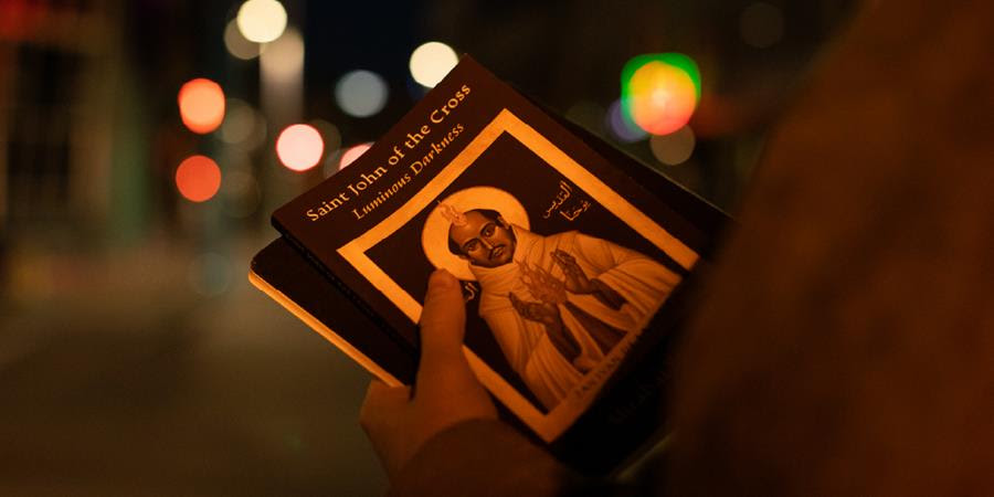 A photo of someone holding the book Saint John of the Cross: Luminous Darkness.