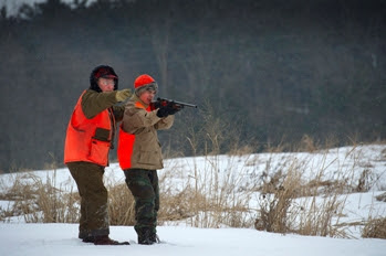 young hunter shooting with mentor