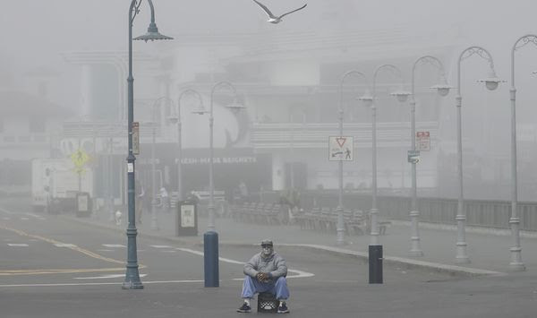 A street performer sits alone at Fisherman&#39;s Wharf in San Francisco, Thursday, March 12, 2020. California Gov. Gavin Newsom said Thursday that sweeping guidance for Californians to avoid unnecessary gatherings to avoid the spread of the new coronavirus will likely extend beyond March. The statewide guidance applies to sporting events, concerts and even smaller social gatherings in places where people can&#39;t remain at least 6 feet (2 meters) apart. For most people, the new coronavirus causes only mild or moderate symptoms. For some it can cause more severe illness. (AP Photo/Jeff Chiu)