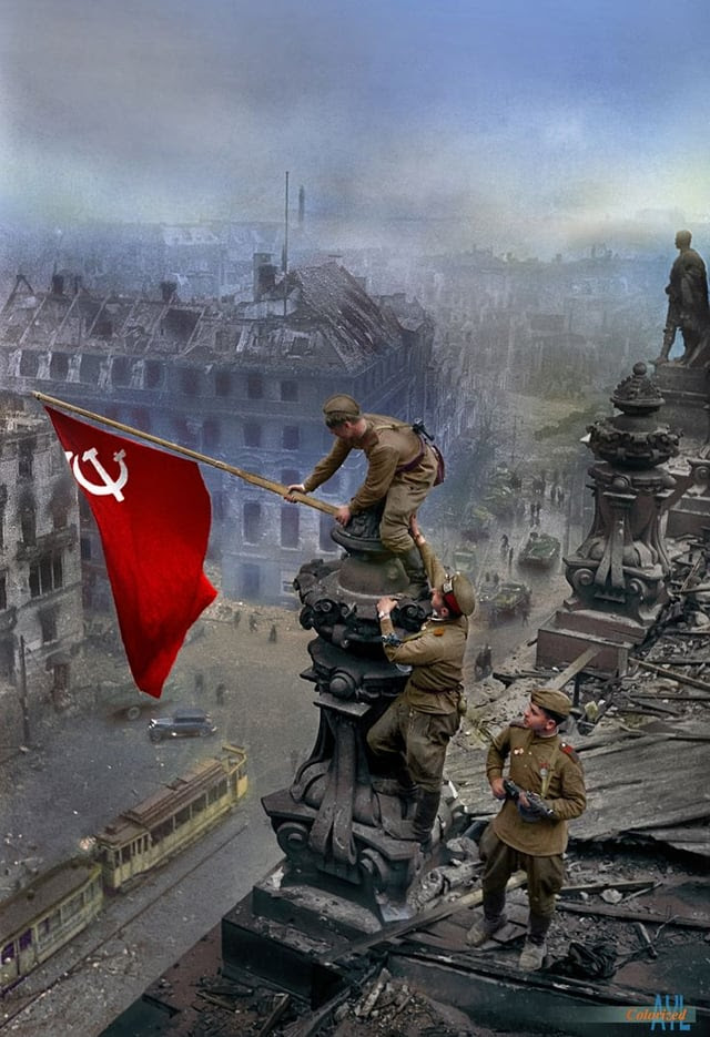 Three Soviet soldiers raise a flag over Berlin, marking the end of the Battle of Berlin, World War Two in Europe, and their Great Patriotic War (02 May, 1945). : r/wwiipics