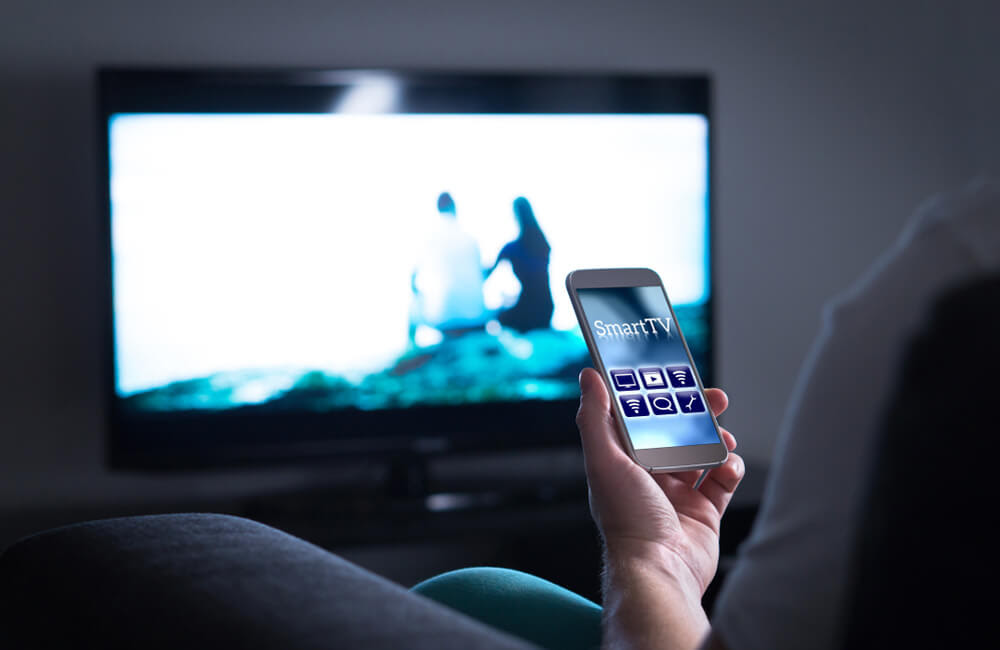 Use TV Remote App on Your Phone ©Tero Vesalainen / Shutterstock.com
