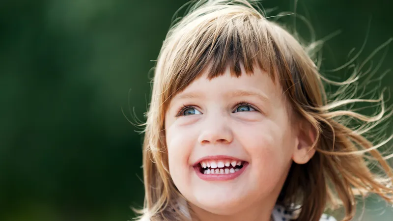 An image of a very smiley young girl