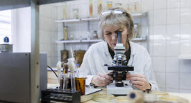 Scientist looking in a microscope