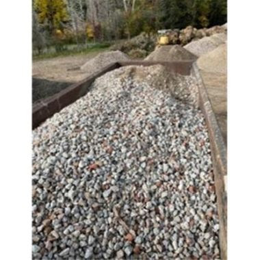 large truck bed filled with rocks and other material