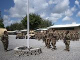 In this Aug. 26, 2019, file photo released by the U.S. Air Force, airmen from the 475th Expeditionary Air Base Squadron conduct a flag-raising ceremony, signifying the change from tactical to enduring operations, at Camp Simba, Manda Bay, Kenya. (Staff Sgt. Lexie West/U.S. Air Force via AP) ** FILE **