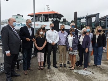 Photo of people posing for a photo in from of Kitsap Transit catamaran Waterman