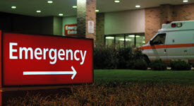 image of emergency sign and ambulance in front of a rural hospital