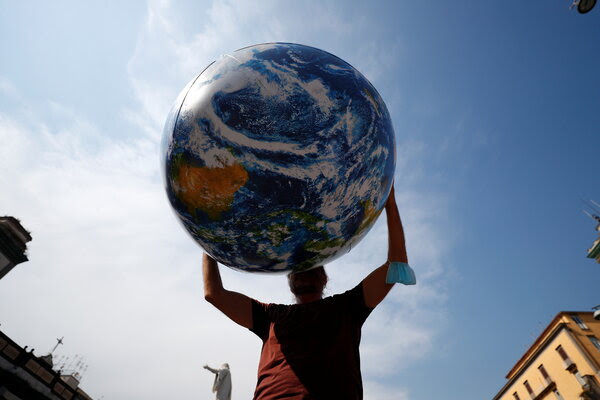 Man holding inflatable world ball.
