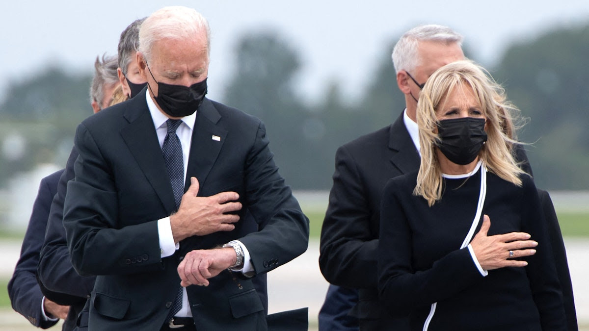 Biden Slammed After Appearing To Look At Watch During Dignified Transfer Of 13 Slain Troops: ‘They Deserved Better’