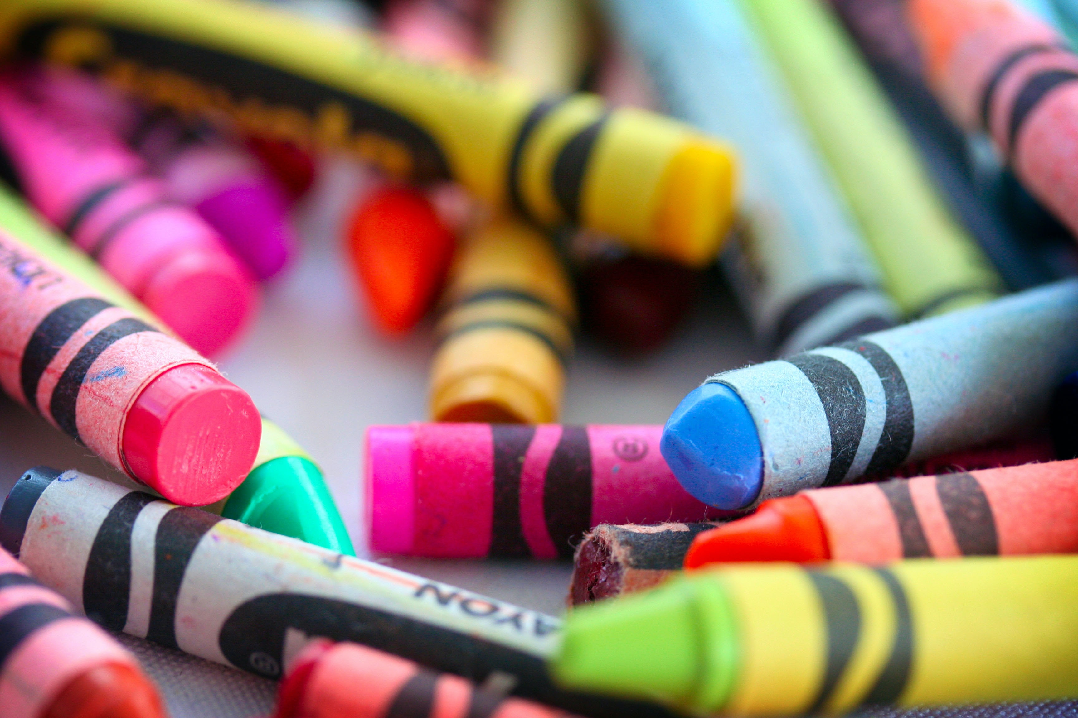 Photo of many brightly colored crayons in a pile. Photo by Sonya Lynne via Unsplash.