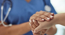Nurse holding another person's hand