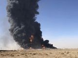 In this Saturday, Feb. 13, 2021, still image taken from video, smoke rises from fuel tankers at the Islam Qala border with Iran, in Herat Province, west of Kabul, Afghanistan. Taliban have taken control of Islam Qala crossing border in western Herat province at the neighboring Iran, an Afghan official and Iranian media confirmed on Thursday, July 8. (AP Photo) **FILE**