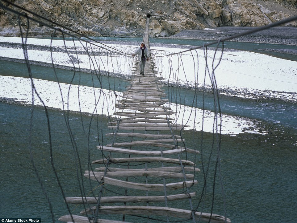 One                                                        way of getting                                                        across the Hunza                                                        River in the                                                        Karakoram                                                        Mountains of                                                        Pakistan is by                                                        the rickety                                                        Hussaini bridge,                                                        which consists                                                        of various                                                        pieces of wood                                                        strapped                                                        horizontally
