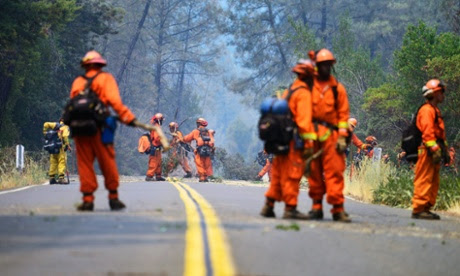 Crews clear brush along a road near the Butts Fire in preparation for a firing operation in the Napa County.