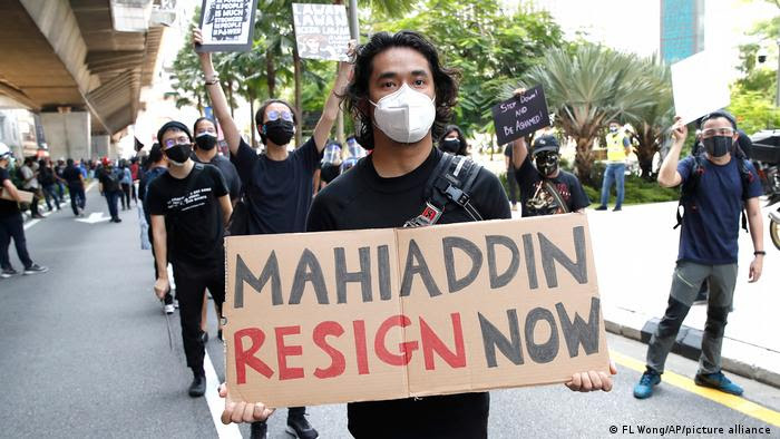 A protester holds placard during a demonstration demanding the prime minister step down near the Independence Square in Kuala Lumpur, July 31, 2021.