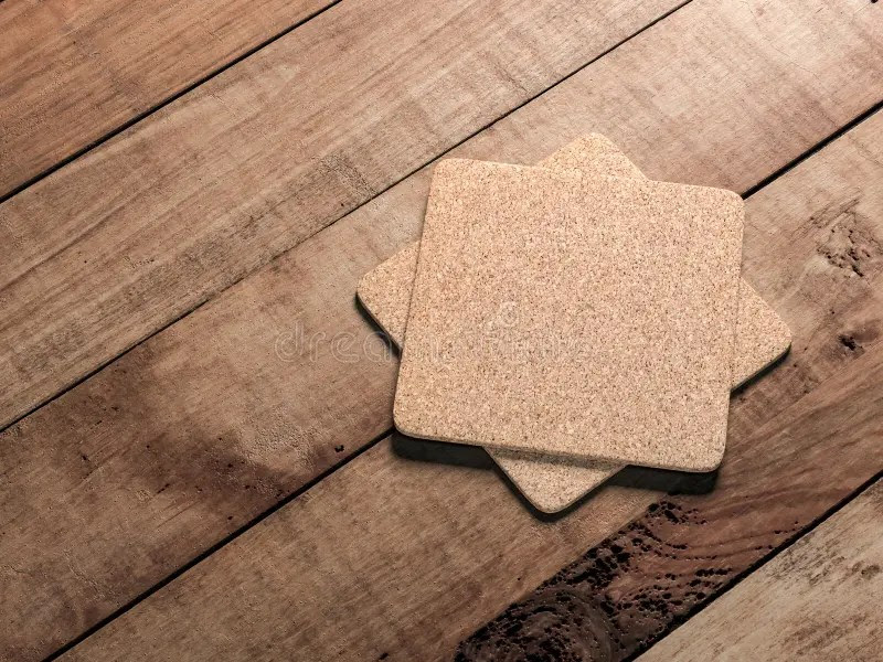 Square Cork Pad or Beer Coaster Mockup on the Wooden Table Outdoor