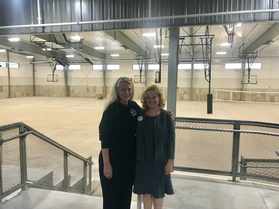 The State Superintendent stands with Andy Jones inside the new B.E.A.S.T. facility, which is a large warehouse-type building with basketball and volleyball courts and wide open space for a variety of activities.