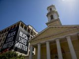 St. John&#39;s Episcopal Church is visible as a large banner that reads Black Lives Matter is hung from the AFL-CIO building on part of 16th Street renamed Black Lives Matter Plaza, a site of protests, Friday, June 12, 2020, near the White House in Washington. The protests began over the death of George Floyd, a black man who was in police custody in Minneapolis. Floyd died after being restrained by Minneapolis police officers. (AP Photo/Andrew Harnik)