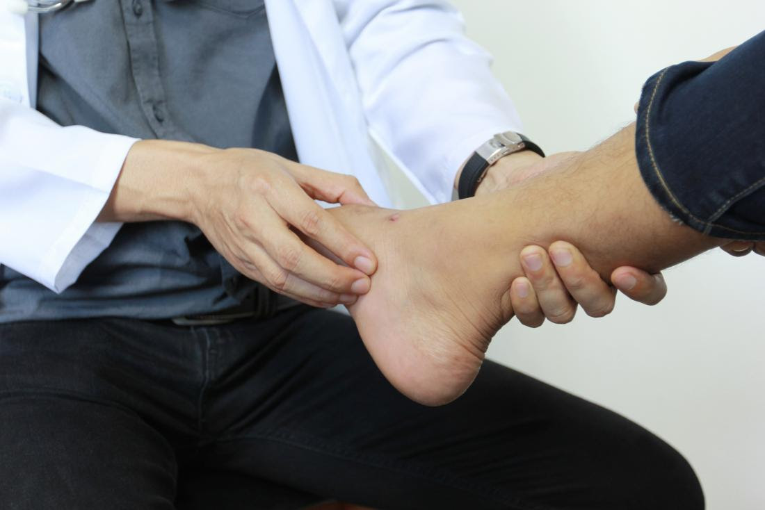 a doctor examines a foot