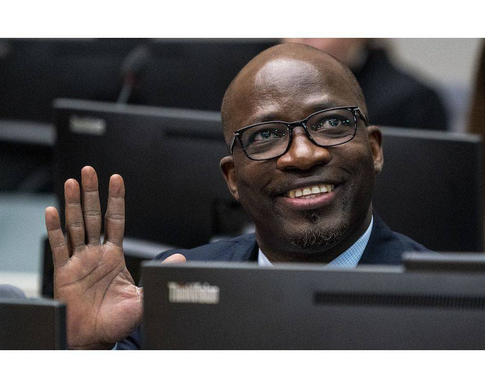 Former Ivory Coast political leader Charles Ble Goude waves prior to the opening of a hearing of the Board of Appeal of the International Criminal Court (ICC) on his request to reconsider the conditions attached to his release in The Hague on February 6, 2020. - Charles Ble Goude, former right-hand of ex-President Laurent Gbagbo, was acquitted along with Gbagbo of crimes against humanity in January 2019, but prosecutors appealed against the verdict. (Photo by Jerry LAMPEN / POOL / AFP) / Netherlands OUT © JERRY LAMPEN / POOL / AFP