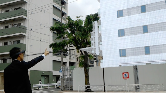 建設地にマンションの完成イメージを表示