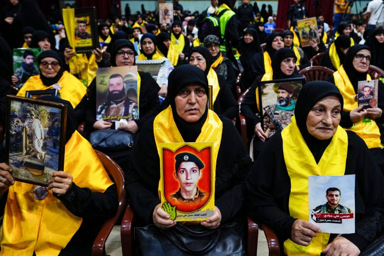 Hezbollah supporters hold pictures of their relatives who died fighting with Hezbollah as they listen to a speech of Hezbollah leader Sayyed Hassan Nasrallah via a video link, during a ceremony marking the "Hezbollah Martyr Day," in the southern Beirut suburb of Dahiyeh, Lebanon, Saturday, Nov. 11, 2023 [Hassan Ammar/AP Photo]