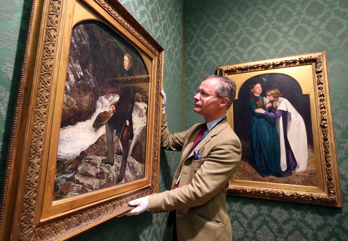 Senior Curator of European Arts Colin Harrison adjusts Portrait of John Ruskin by John Everett Millais that was allocated to the Ashmolean Museum in Oxford by the Arts Council England under the Acceptance in Lieu of Inheritance (AIL) scheme. Photo by Steve Parsons/PA Images via Getty Images.