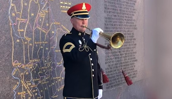 Bugler plays taps at memorial on Generals bugle