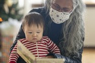 Hopi grandmother reading to a baby