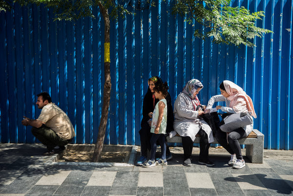 Iranian women sit on street bench in Tehran on&nbsp;Aug. 2.&nbsp;(Nazanin Tabatabaee Yazdi/TIMA via Reuters)</p>
