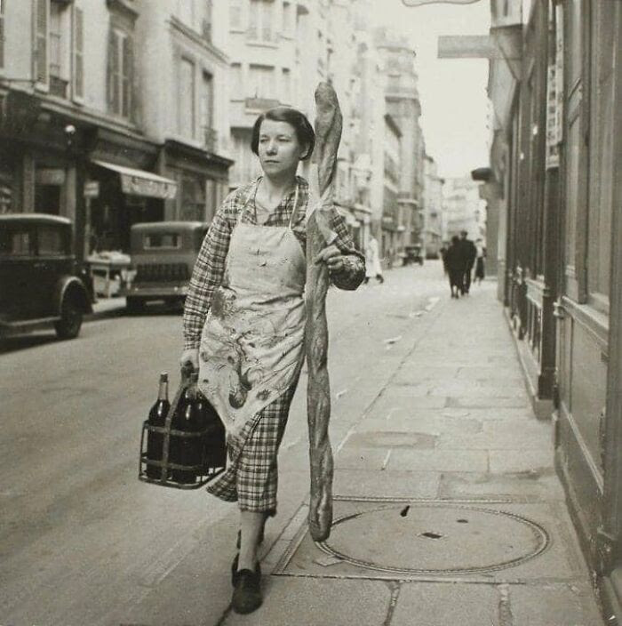 A Woman On A                                                      Mission With Her                                                      Baguette And Six                                                      Bottles Of Wine.                                                      (Paris 1945 - By                                                      Branson Decou)