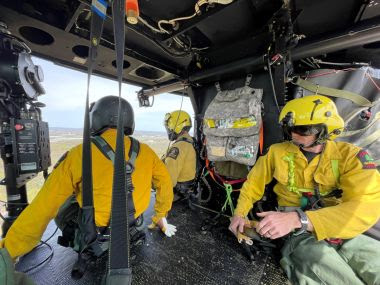 Three Rangers in a helicopter during hoist training