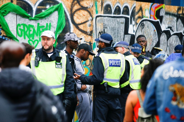 Police stop and search people during the Notting Hill Carnival in London, Britain August 27, 2018. REUTERS/Henry Nicholls