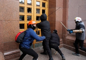 Unidentified men break the door of the Kiev City State Administration (Kiev City Council) building during a rally held by supporters of EU integration in Kiev