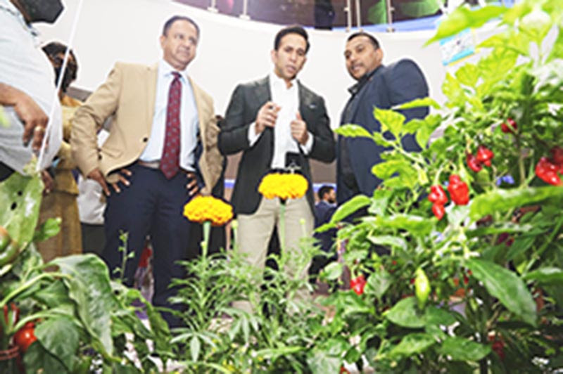 George Singh, left, Minister of Rural Development and Local Government Faris Al-Rawi, centre, and Minister in the Ministry of Agriculture, Land and Fisheries Avinash Singh look at a display of hydroponic plants by Plant Doctors HydroAqua at the Agriculture & Food Expo at the Gulf City Shopping Complex, La Romain, yesterday.