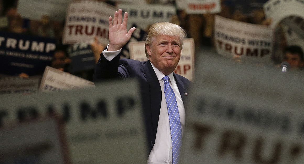 A picture of Trump waving in a crowd, surrounded by supporters